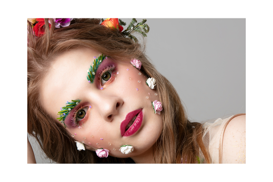 woman with flower crown and flowers on her cheeks