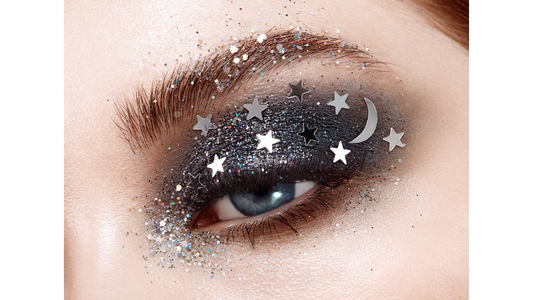 model wearing smoky gray eyeshadow with silver moon and star sequins on her eyelid