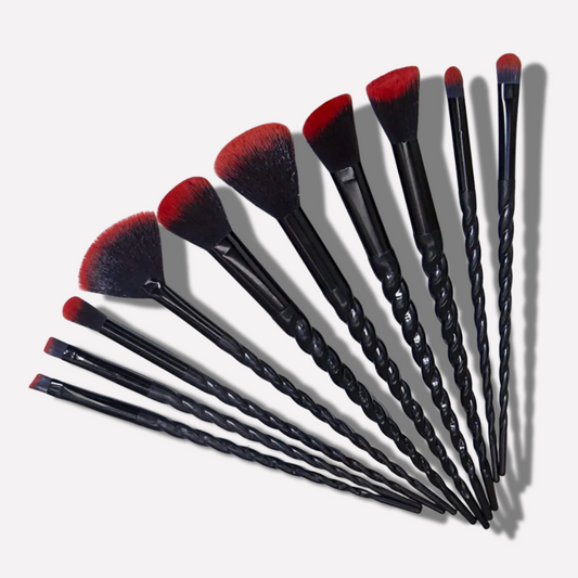 Set of makeup brushes with black handles and red bristles on a white background