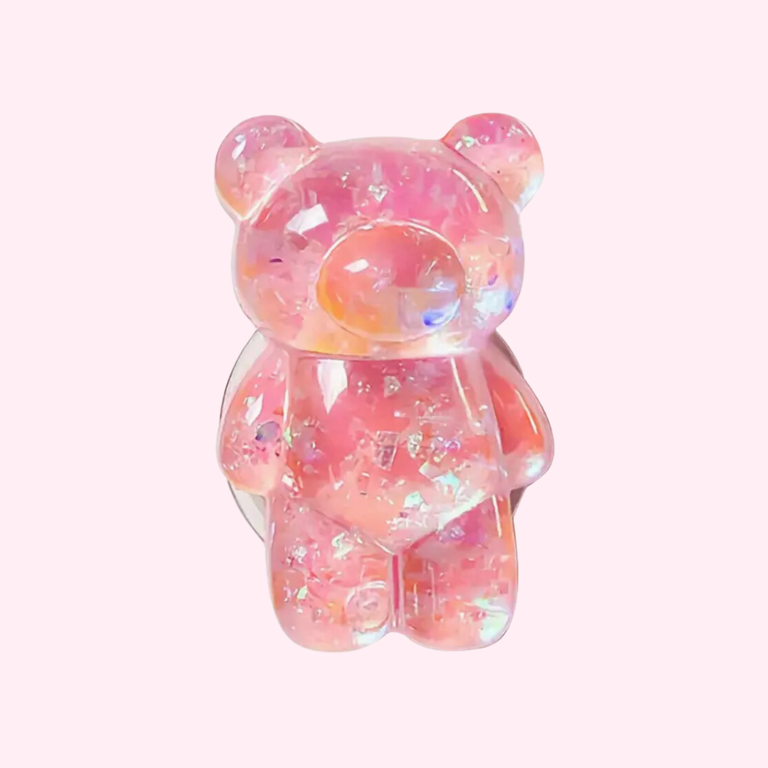 A pink translucent gummy bear-shaped phone pop holder with a shiny, glittery finish.