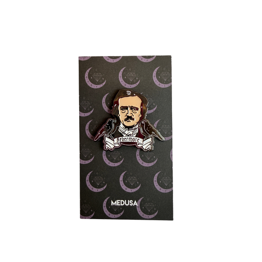 Pin with a literary-themed design on a black card with crescent moon patterns, branded 'Medusa'.