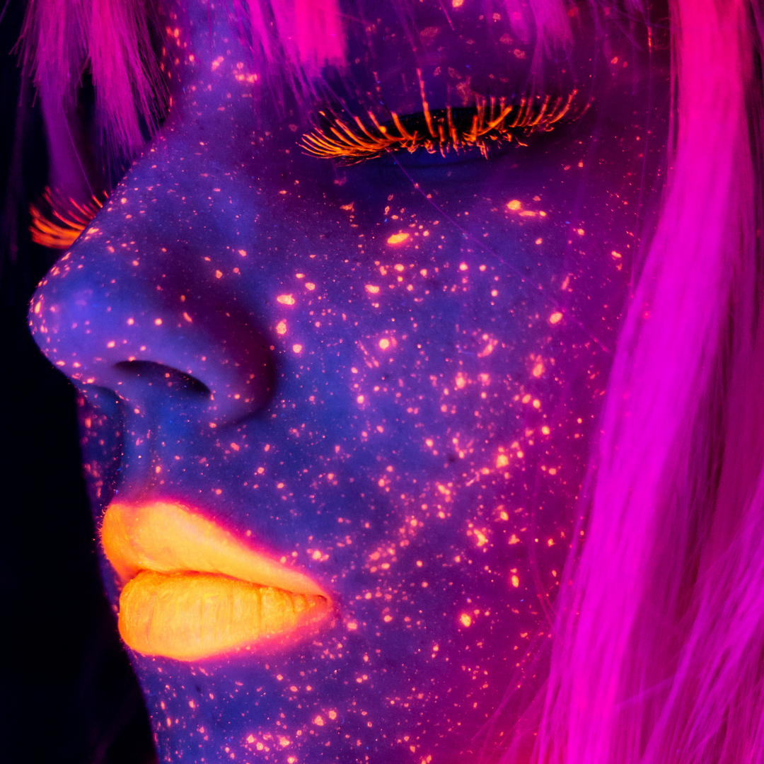 model wearing uv neon makeup under a blacklight