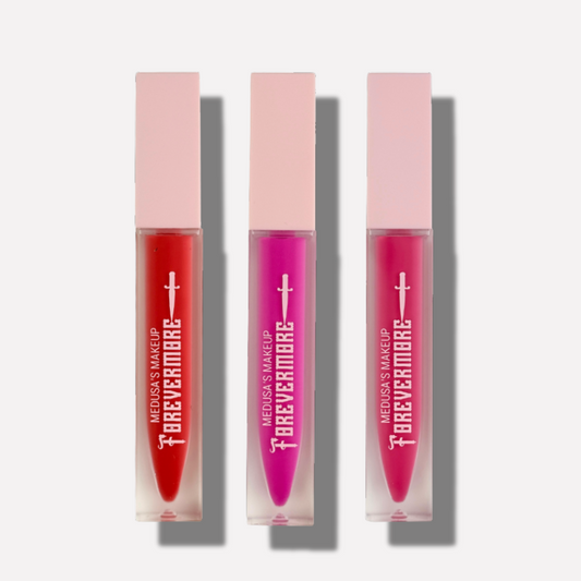 Three lip glosses in red, pink, and purple with 'Forevermore' packaging on a white background.