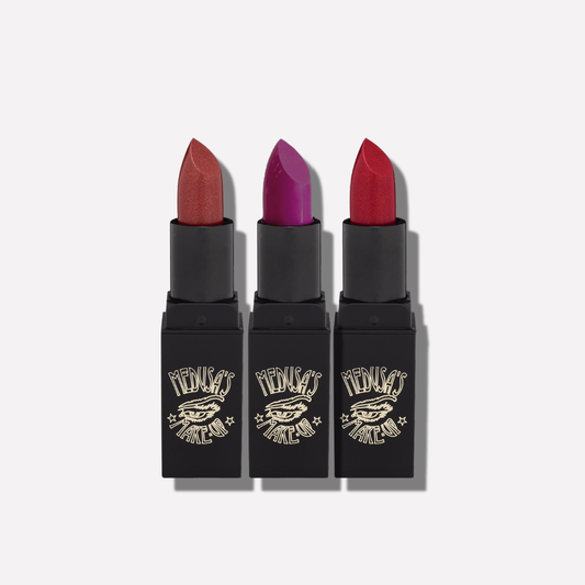 Three lipsticks with different colors on a white background