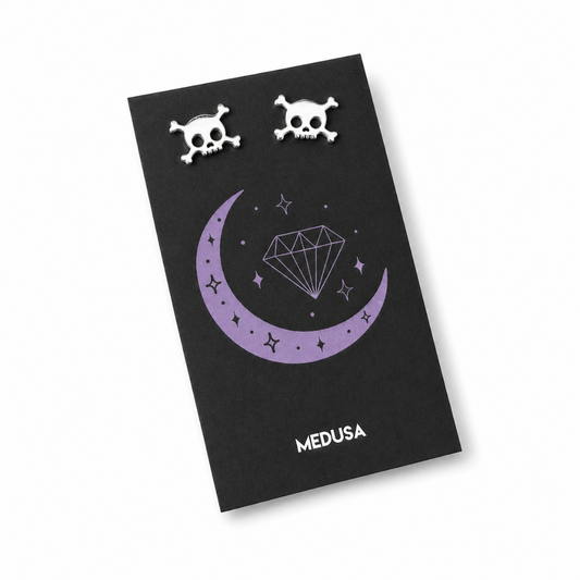 Black card with skull designs and 'MEDUSA' branding on a white background