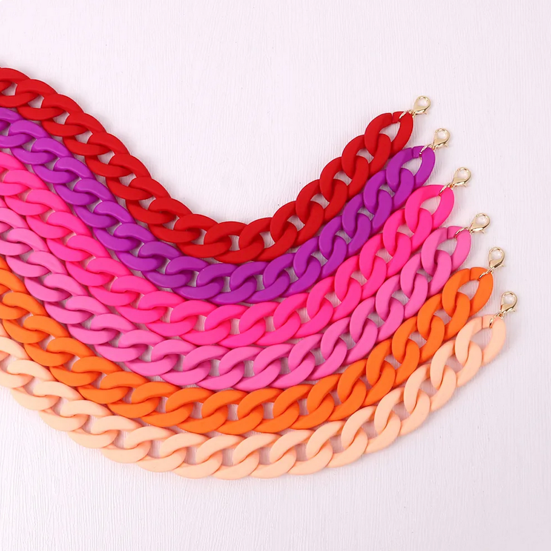 a grouping of rainbow chain link necklaces
