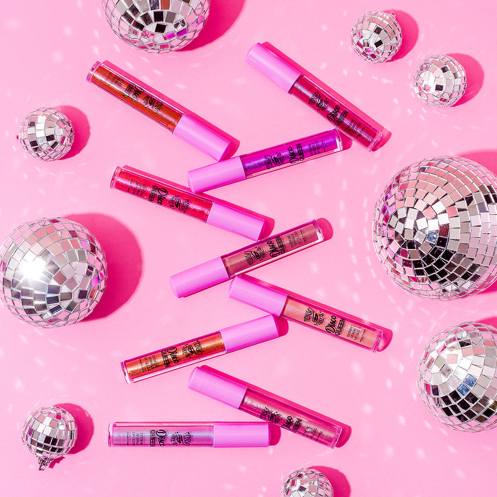 Disco Queen lip gloss displayed with disco balls on a pink background