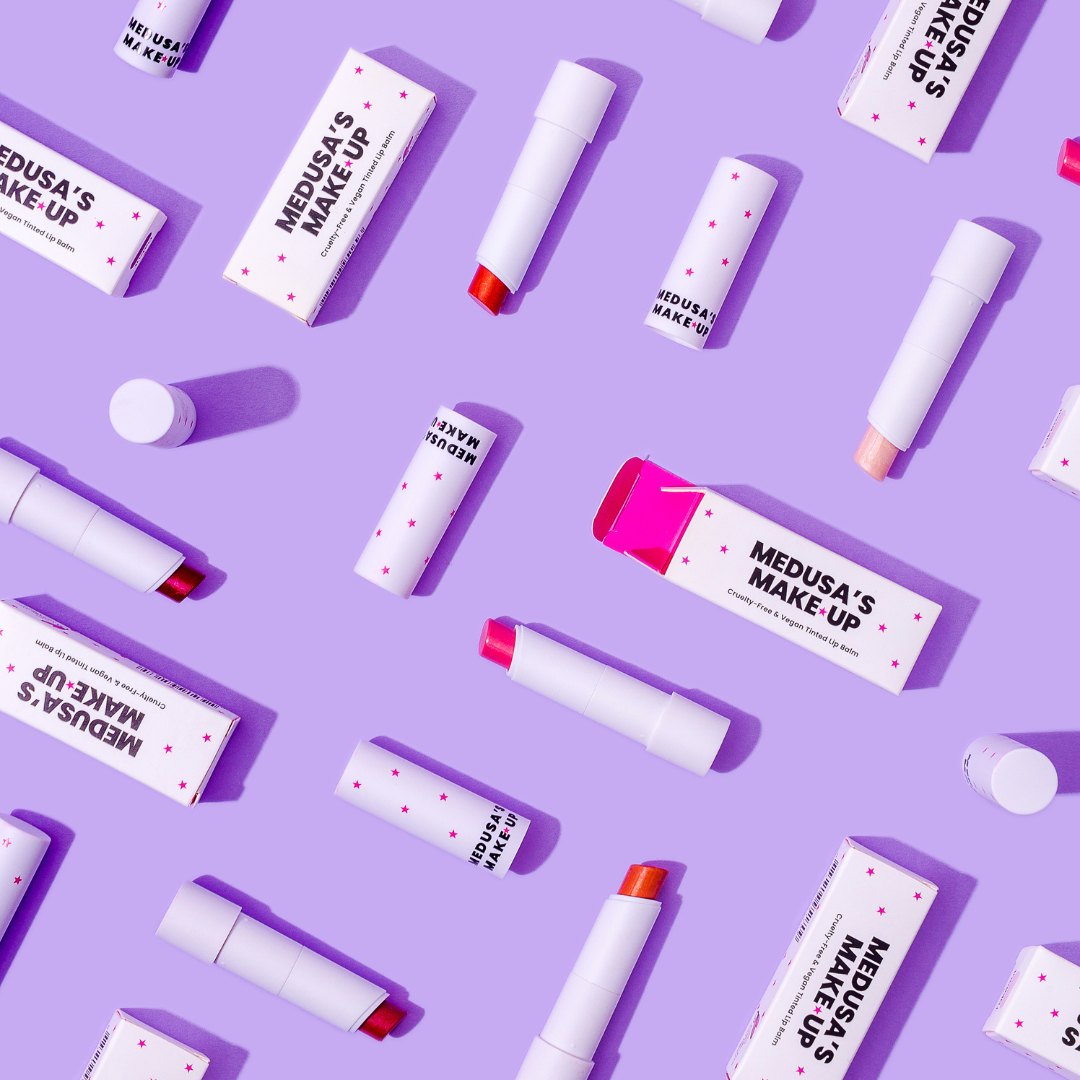 Vegan tinted lip balm displayed on a purple background