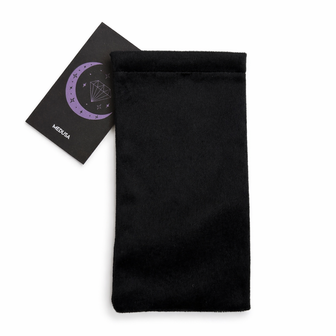 Black fabric with a card featuring symbols on a white background
