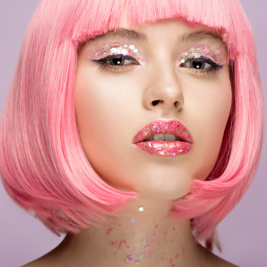 model wearing pink wig and glittergasm on eyes, lips and neck