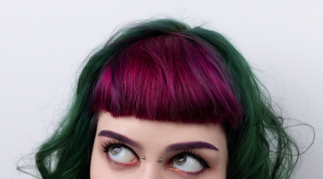 woman with dark green hair and burgundy bangs