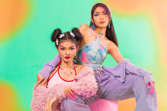 two women dressed in colorful 90s attire