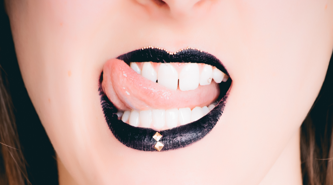 woman with black lipstick sticking tongue out