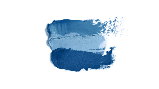 swatches of blue makeup on a white background