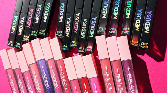 lipsticks and lip glosses on a pink background