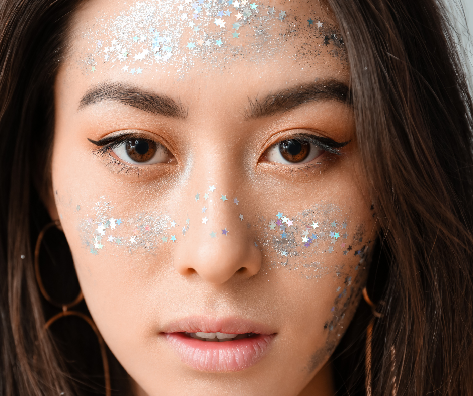 model wearing silver glitter makeup on her cheeks and forehead