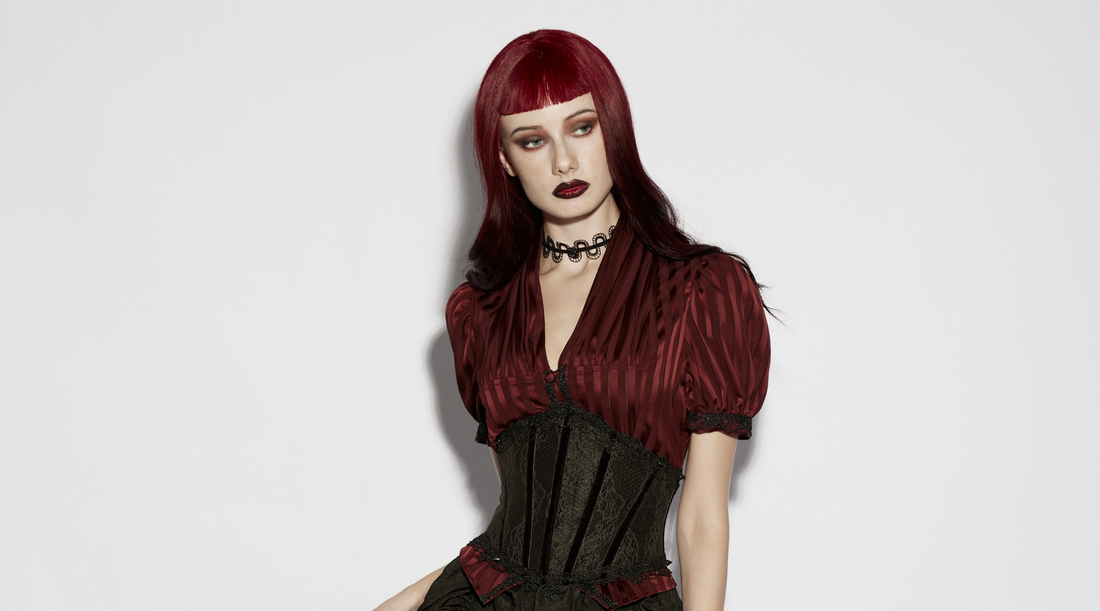 woman with maroon hair, goth makeup and clothing