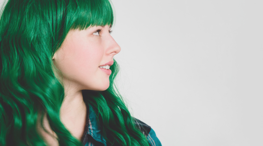 woman's side profile with dark green hair