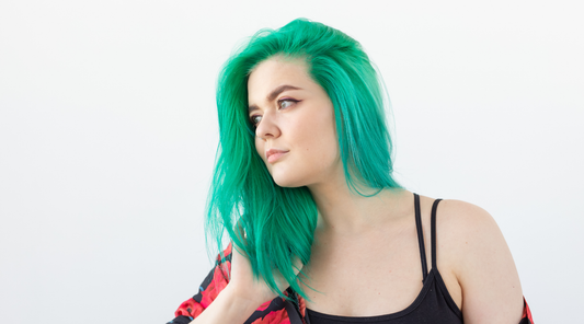 woman with green hair looking to the side