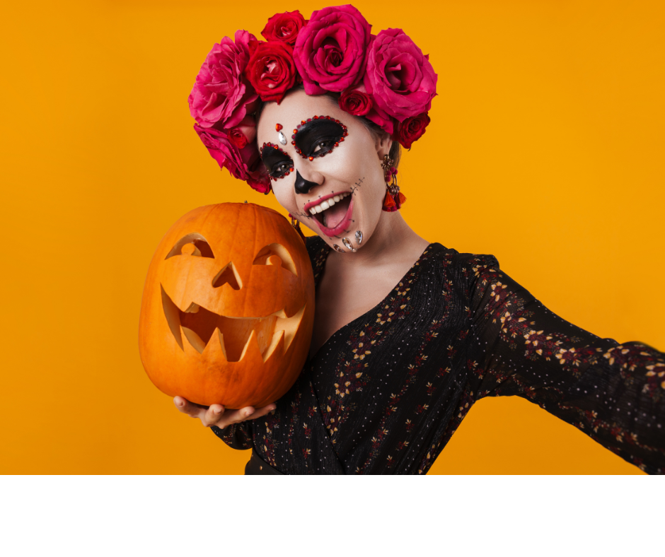 model wearing skull makeup with a flower crown resembling a sugar skull, holding a jackolantern