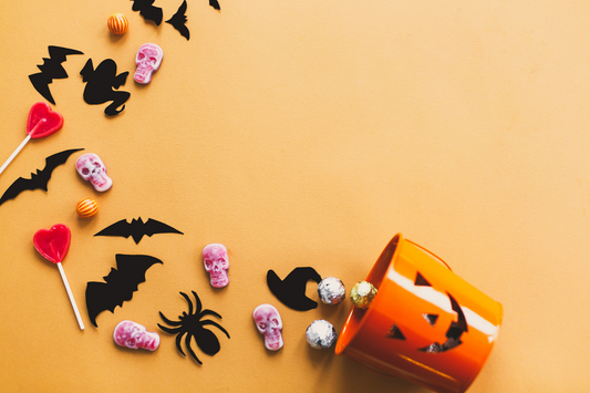 halloween candy spilled onto an orange background