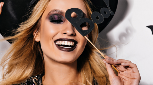 woman with smoky makeup and a sign that reads "boo!"