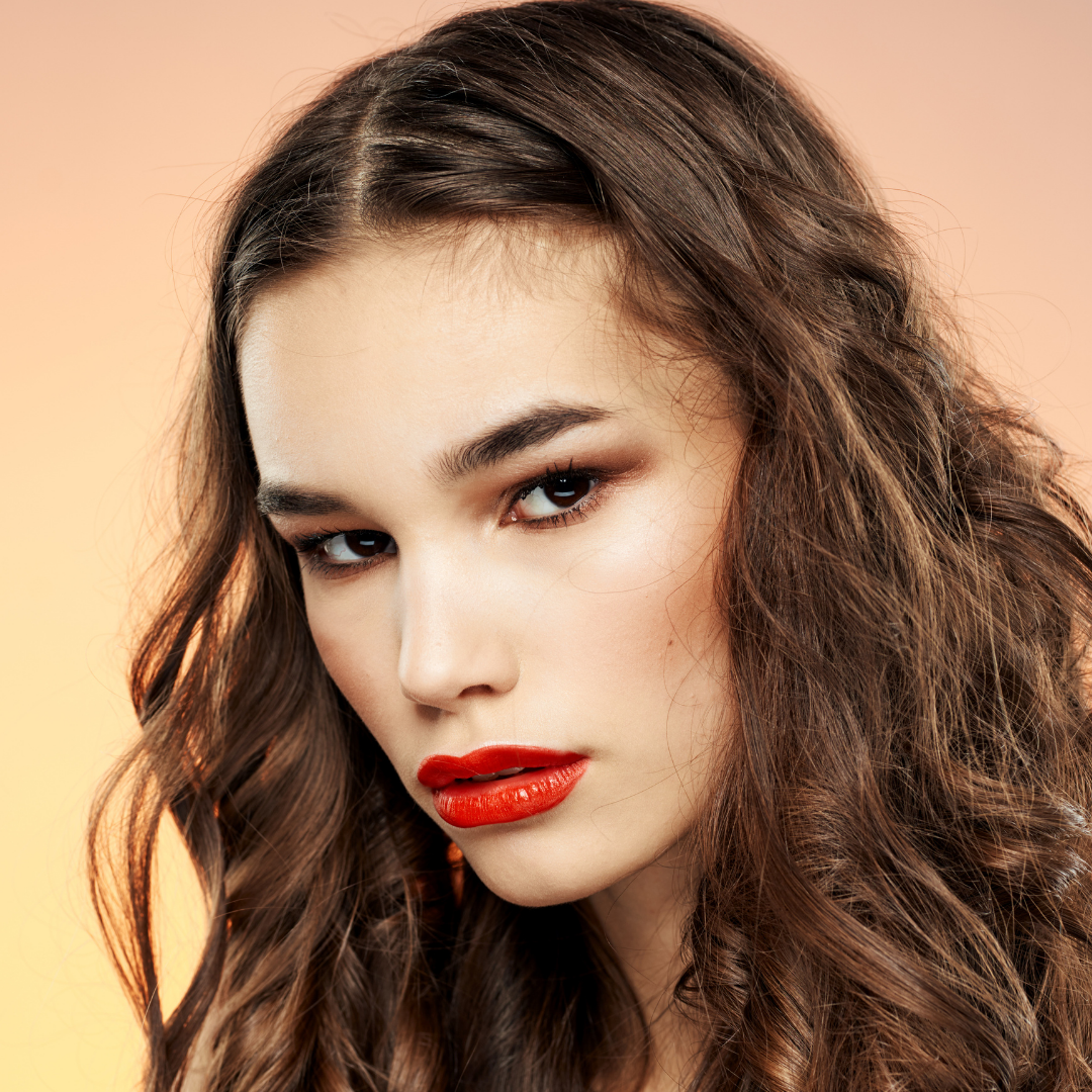 Young model wearing smokey eye and red lipstick by Medusa's Makeup.