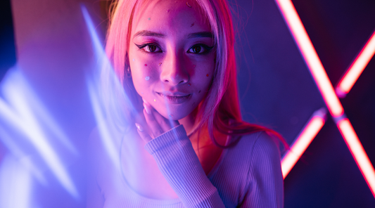 girl with neon pink hair under a night club blacklight