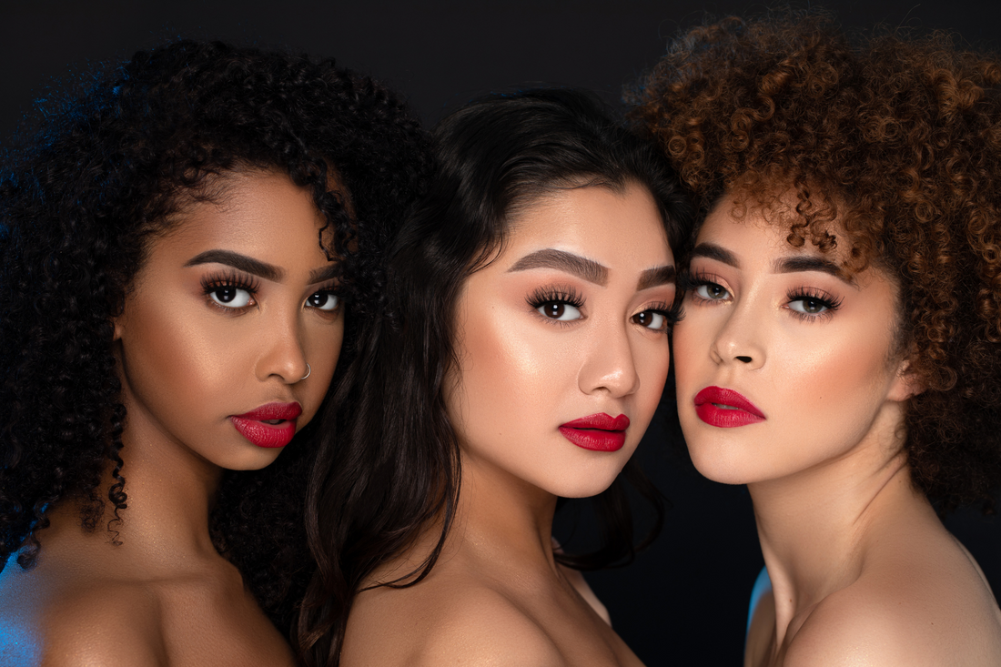 models of various skin tones wearing red lipstick