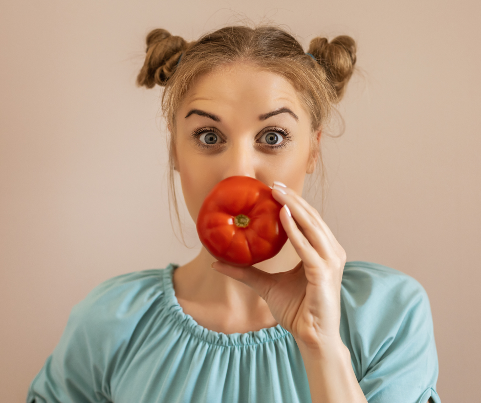woman holding a tomato