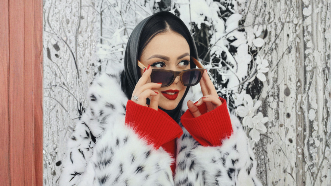 woman in snowy environment with fur coat and sunglasses