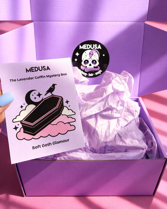 Purple mystery box with a 'Medusa' label and a card featuring a coffin illustration.
