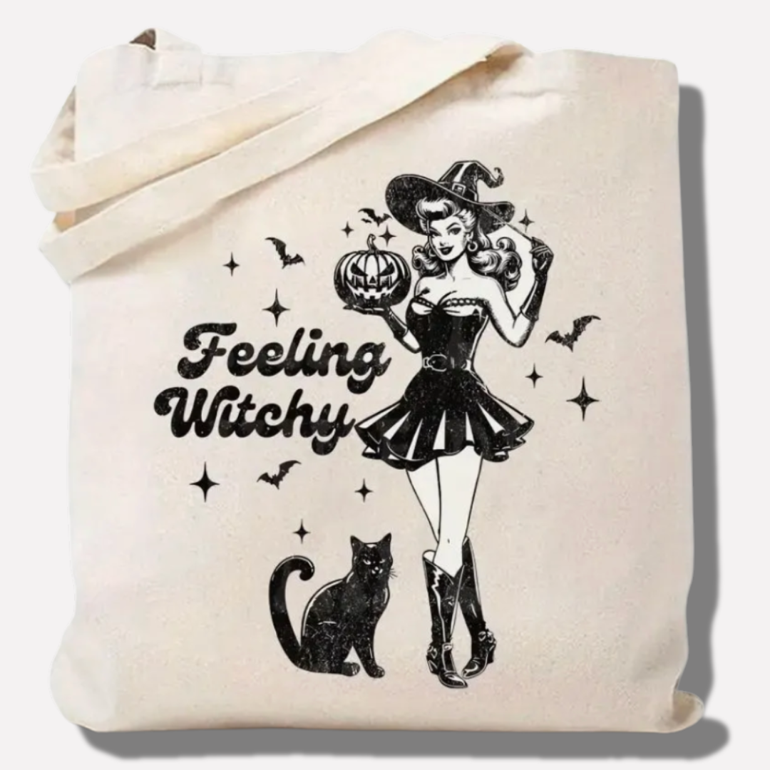 Tote bag with a Halloween design featuring a witch, black cat, and 'Feeling Witchy' text.