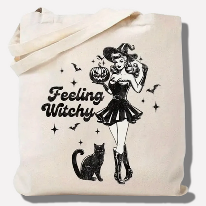 Tote bag with a Halloween design featuring a witch, black cat, and 'Feeling Witchy' text.