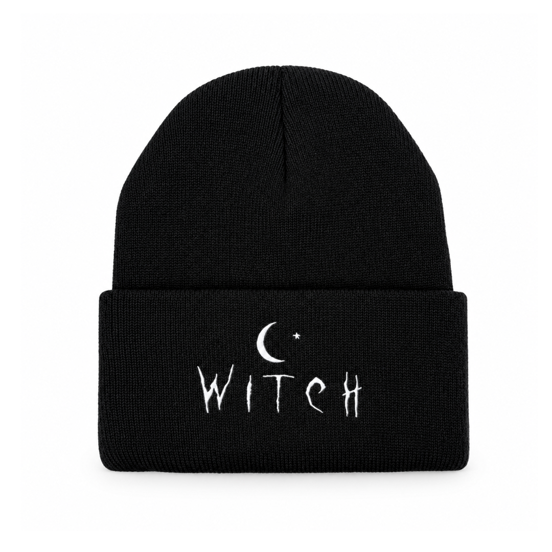 A black knit cuffed beanie with white embroidered text reading 'WITCH' and a crescent moon and star graphic on the front cuff, shown against a plain white background.