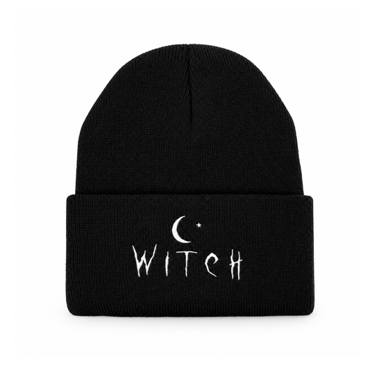 A black knit cuffed beanie with white embroidered text reading 'WITCH' and a crescent moon and star graphic on the front cuff, shown against a plain white background.