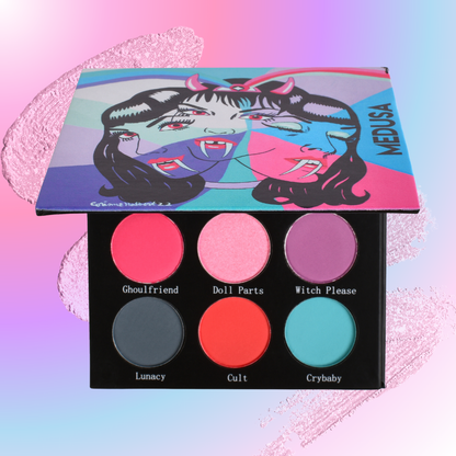 Makeup palette with colorful eyeshadows and a 'Medusa' themed box on a gradient background