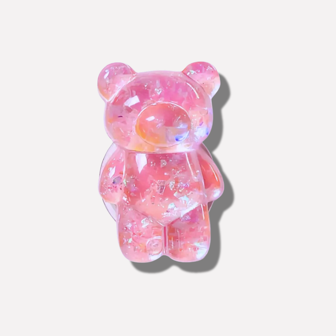 Pink and purple gummy bear toy on a white background