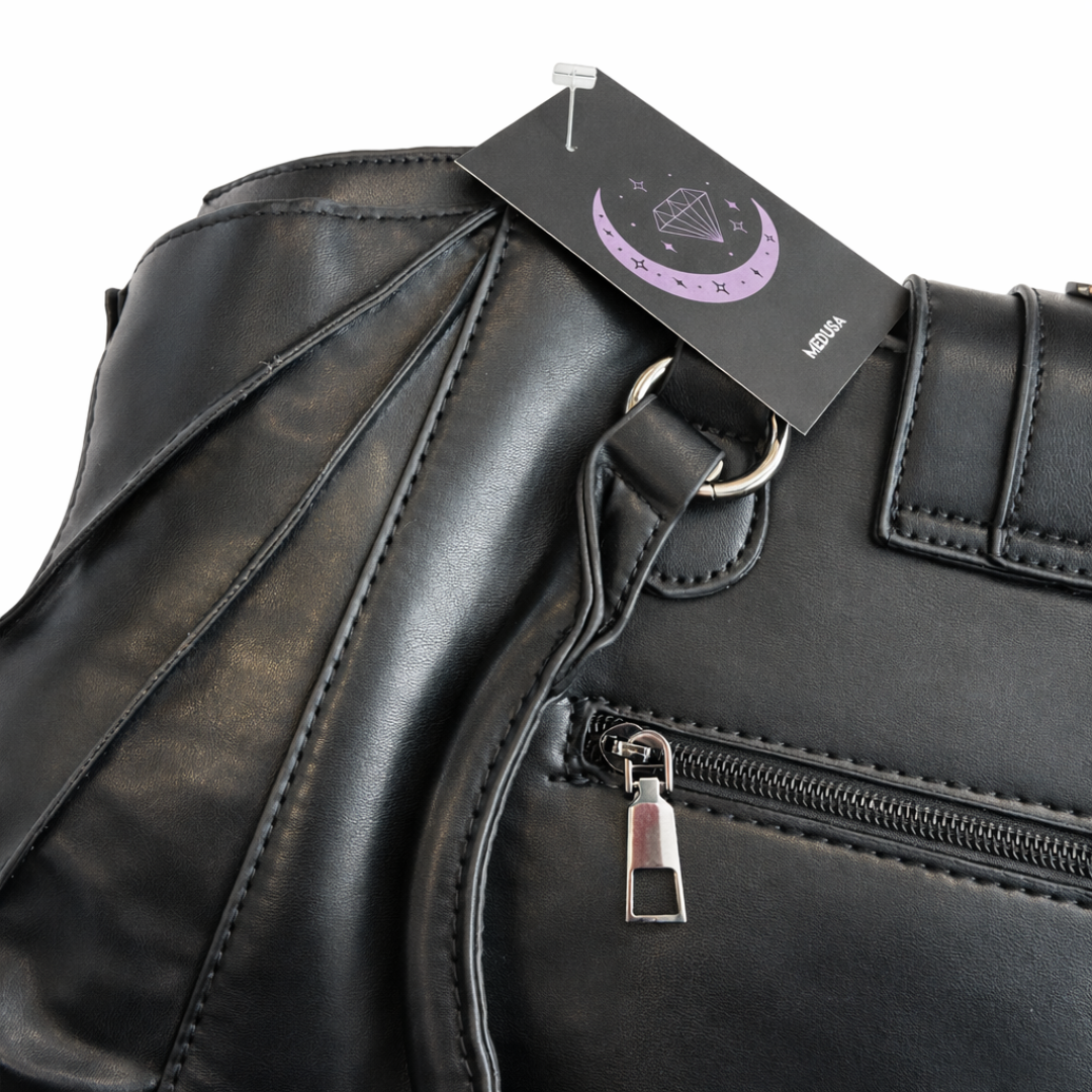 Black leather bag with a visible brand tag on a white background