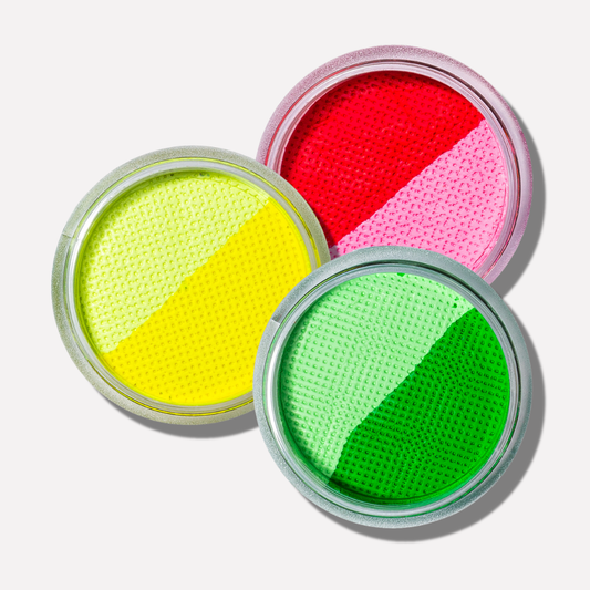 Three open containers of colorful powder, each with a different color on a white background.