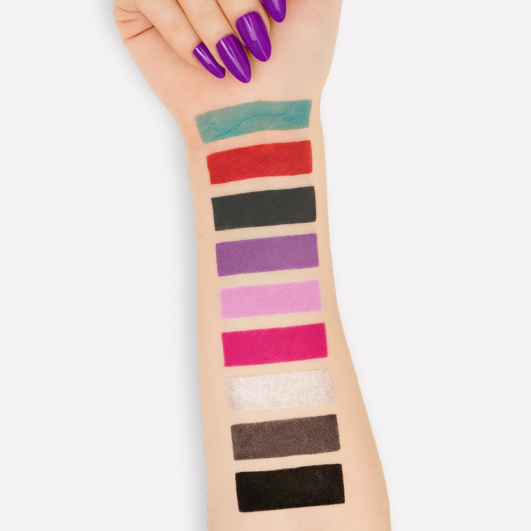 Nail color swatches on a person's arm with purple nail polish.