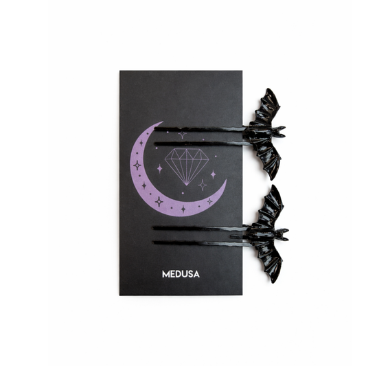 Black hair ties with decorative design on a black card featuring 'MEDUSA' branding.