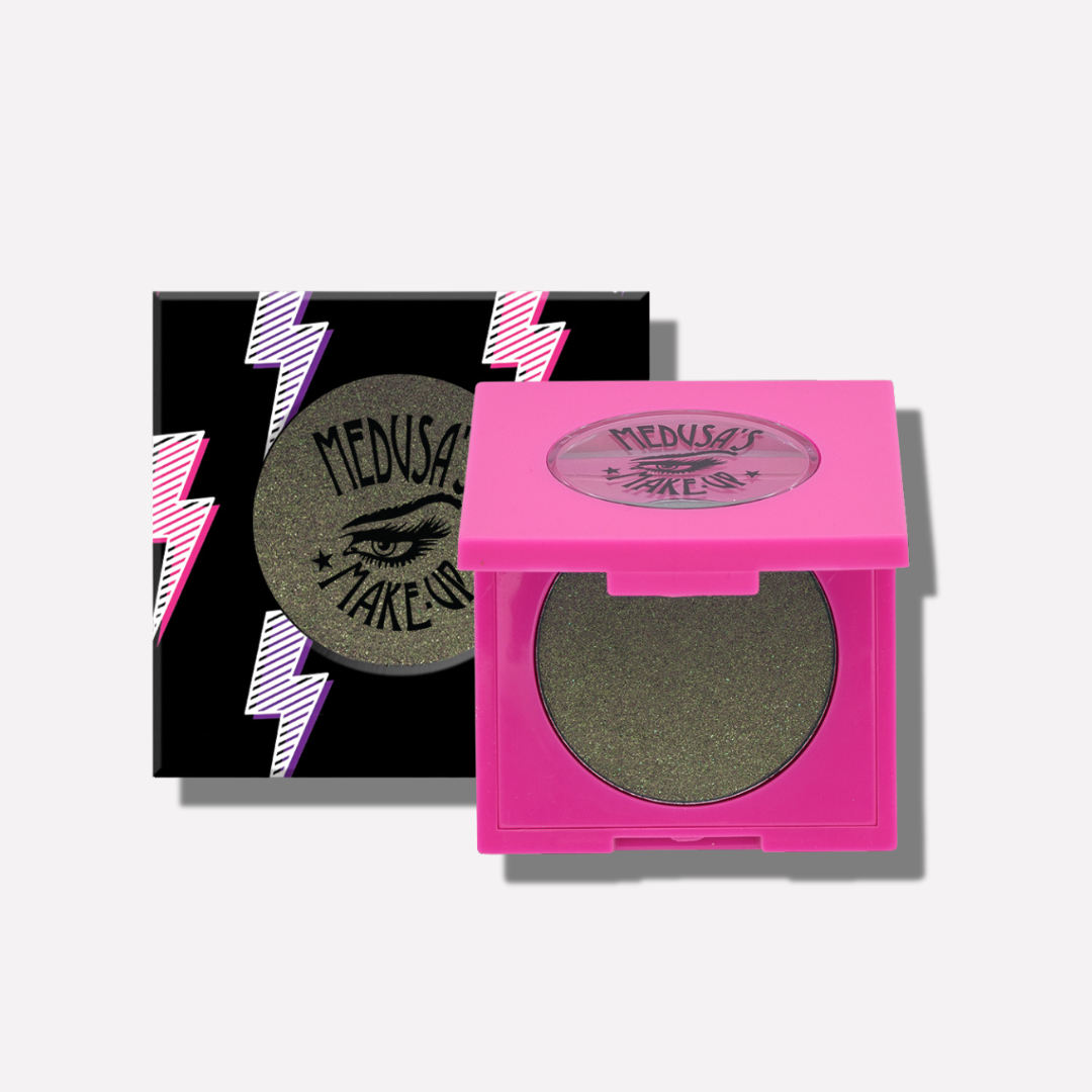 Green eyeshadow in a pink compact with 'Medusa's Make-Up' branding on a white background