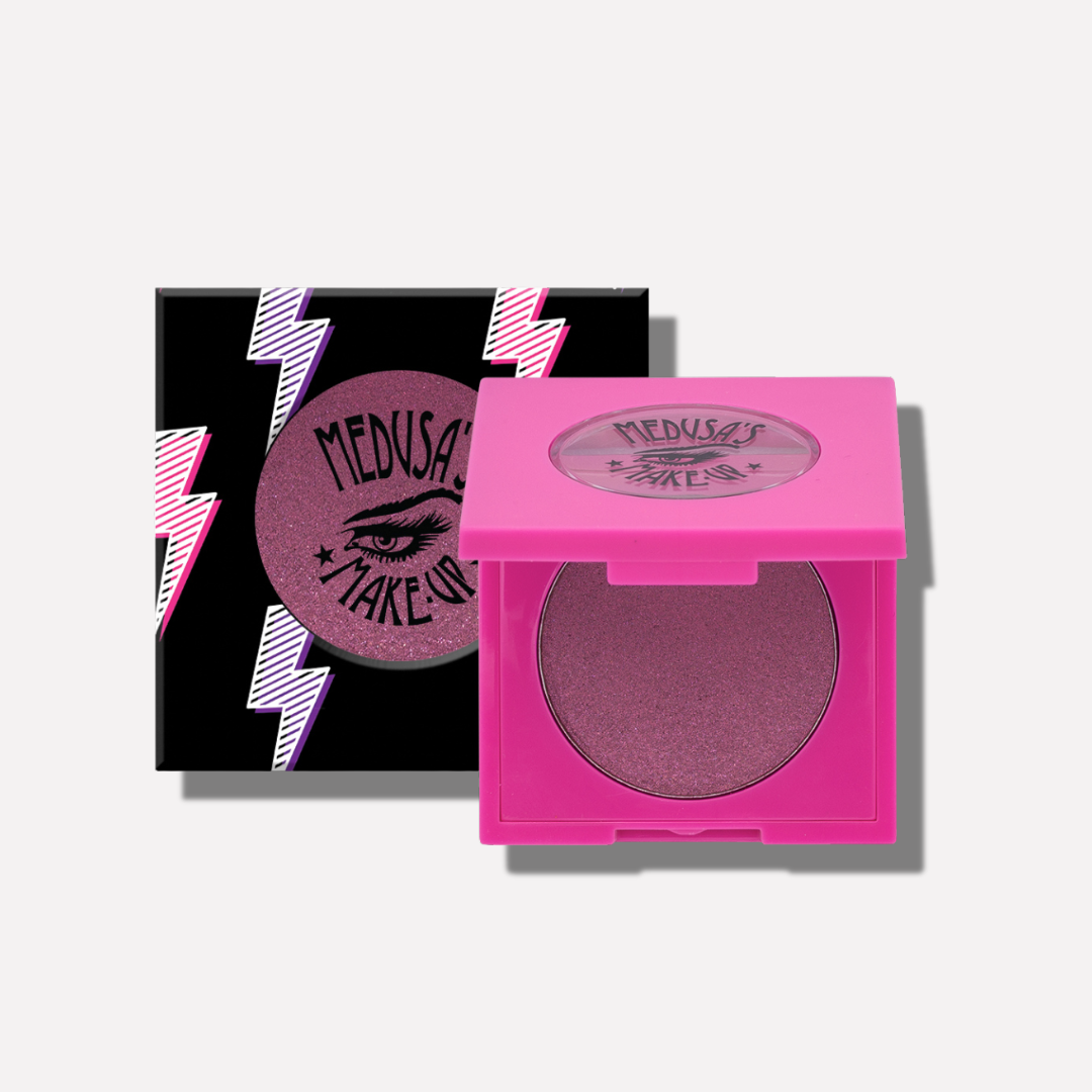 Pink makeup compact with 'Medusa' branding on a white background