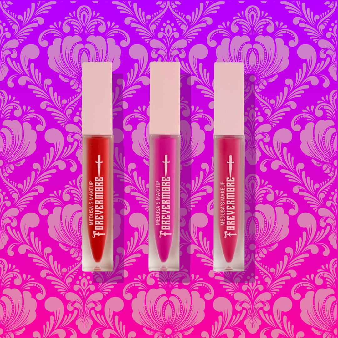 Three lip glosses from Forevermark on a pink and purple patterned background