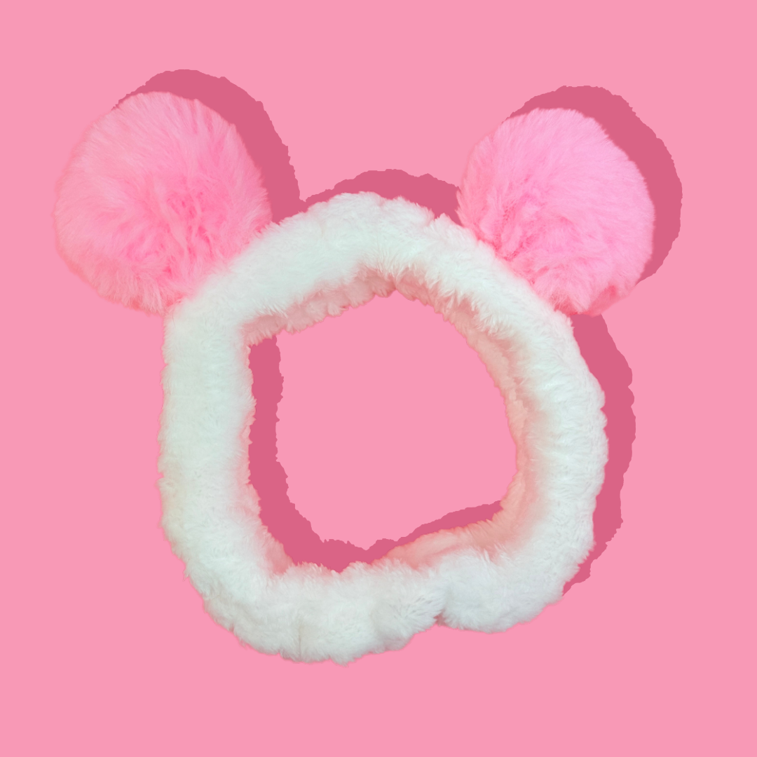 Pink and white fluffy headband with ears on a pink background