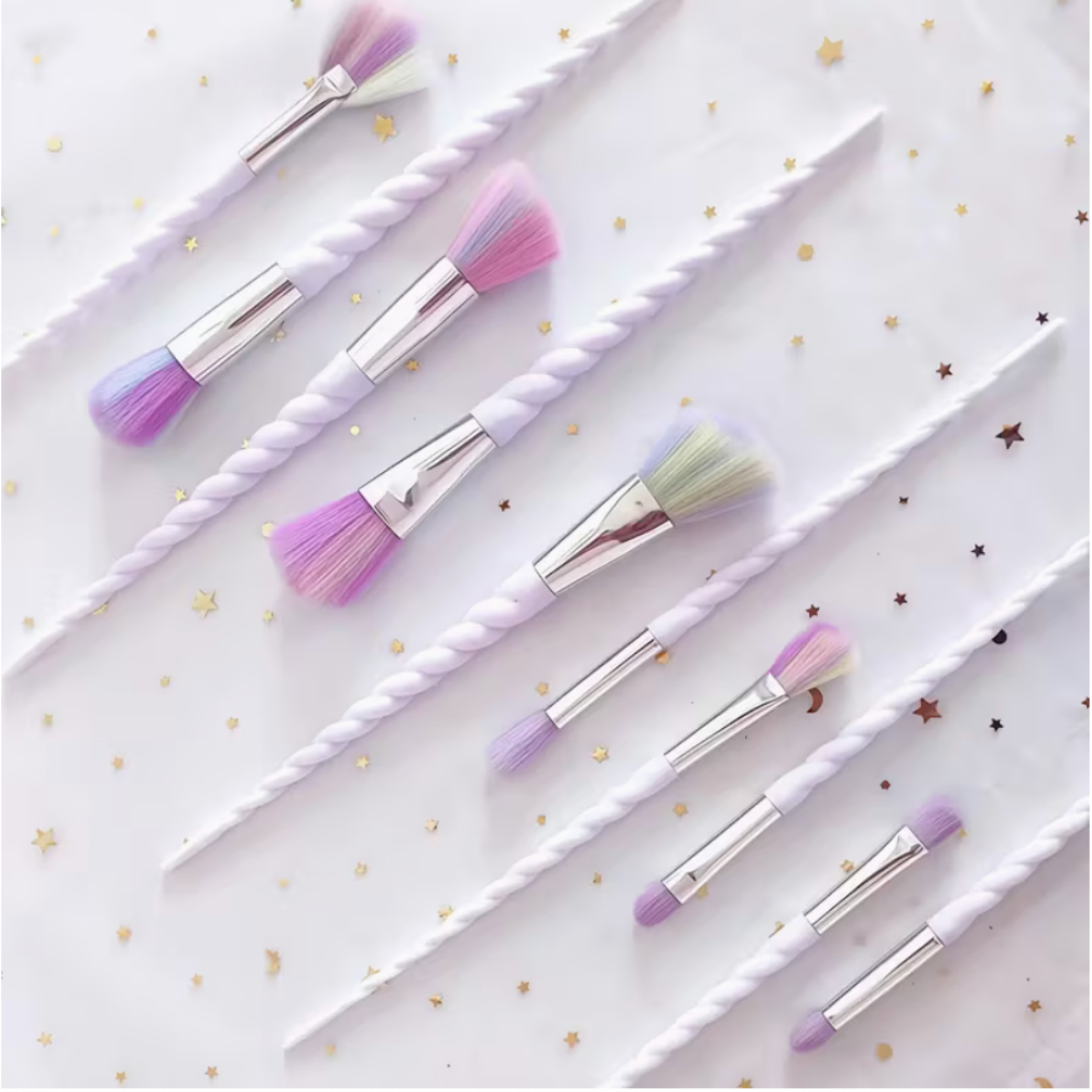 Set of makeup brushes with unicorn handles on a white background