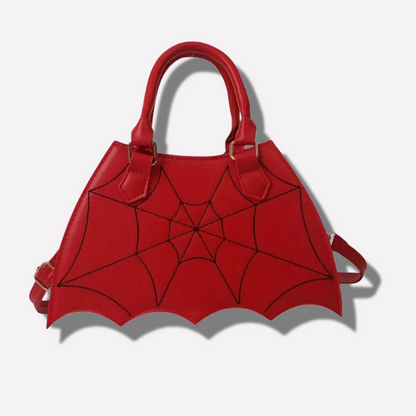 Red handbag with spider web design on a white background
