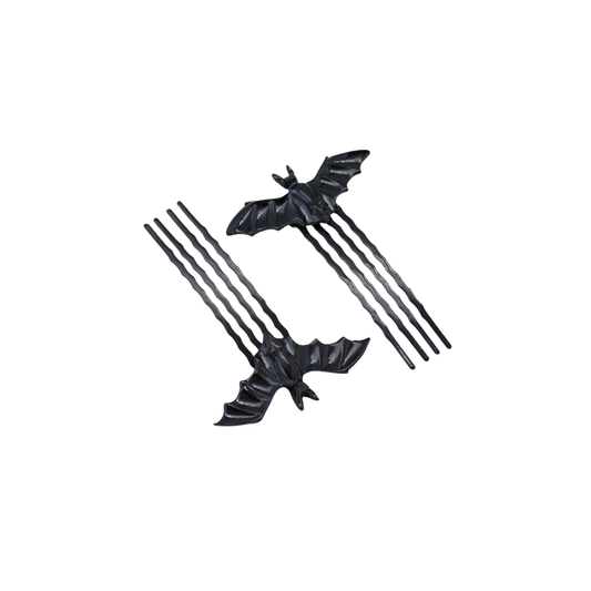 Black bat-shaped hair accessories on a white background