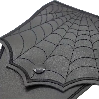 Gray leather wallet with spider web design on a white background